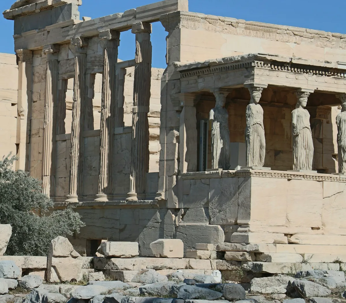 Marble columns and sculpted figures at the ancient Acropolis in Athens